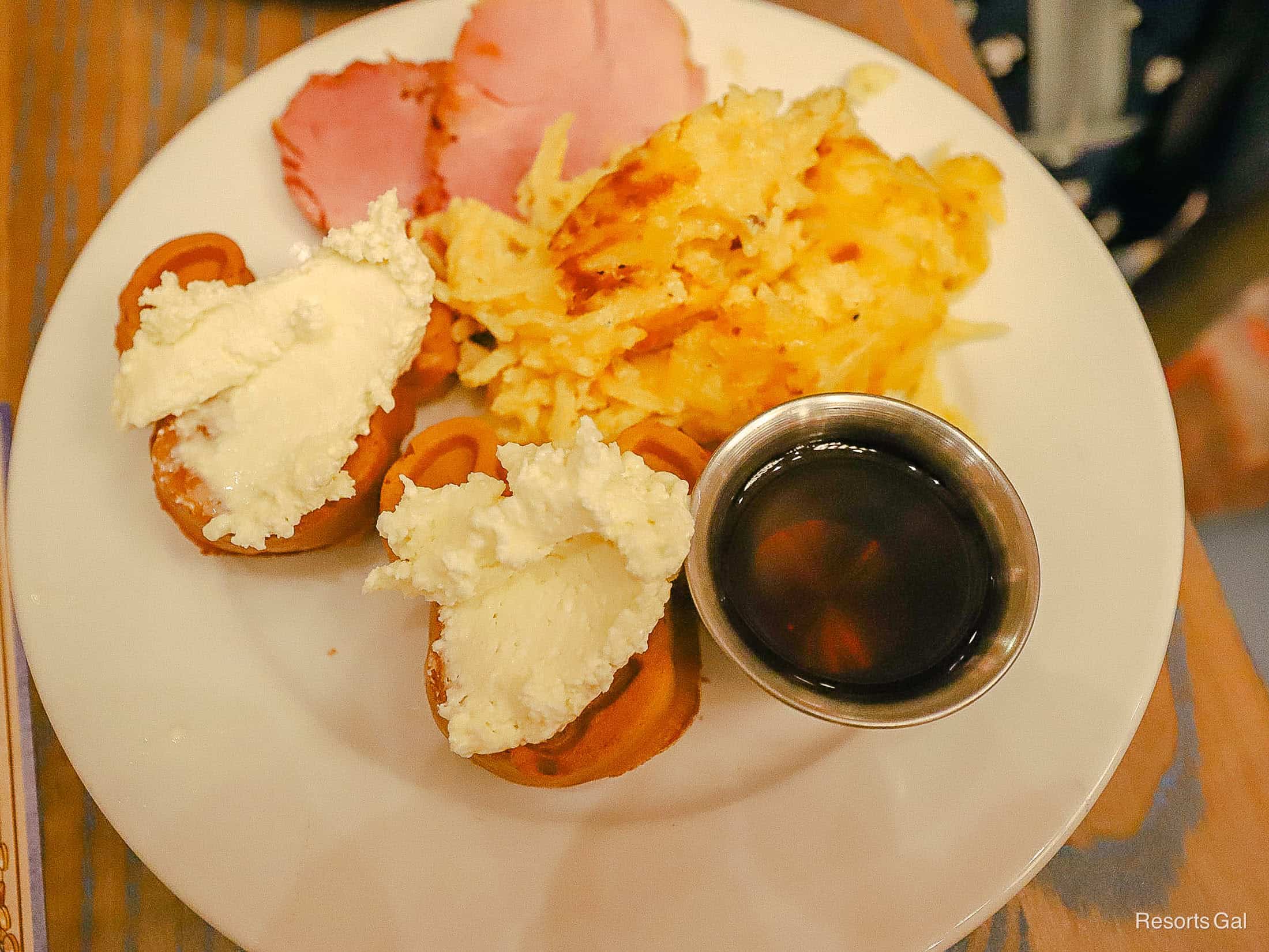 a plate with Mickey waffles, potato hash, and ham from 1900 Park Fare 