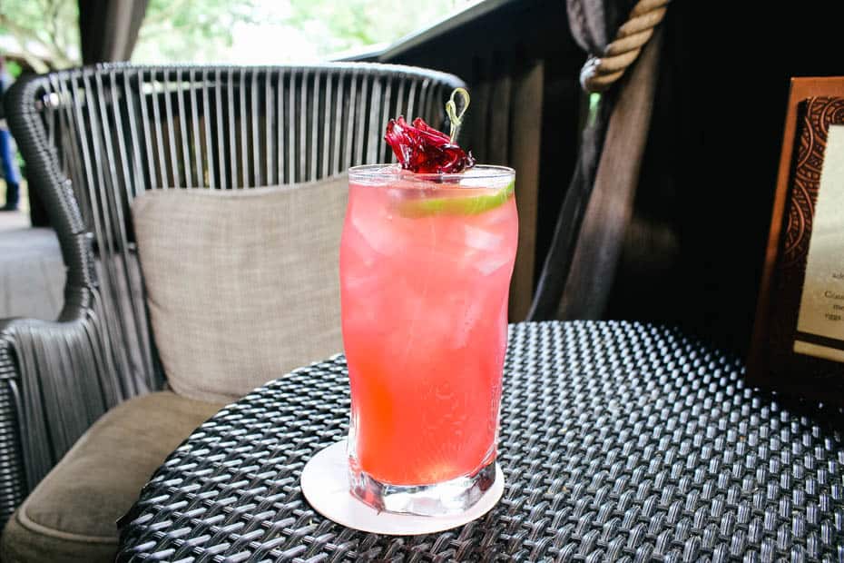 a pink beverage with floral garnishes 
