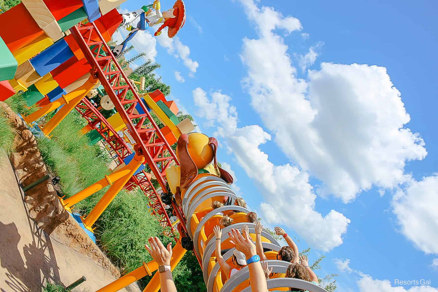 guests riding Slinky Dog Dash with their arms up 
