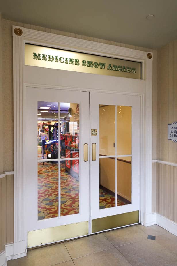 a pair of double doors that lead to the Medicine Show Arcade 