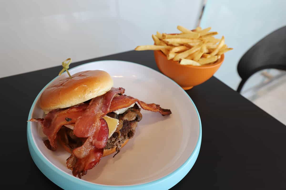 the French Bistro Burger from Connections Eatery at Epcot with a side of fries 