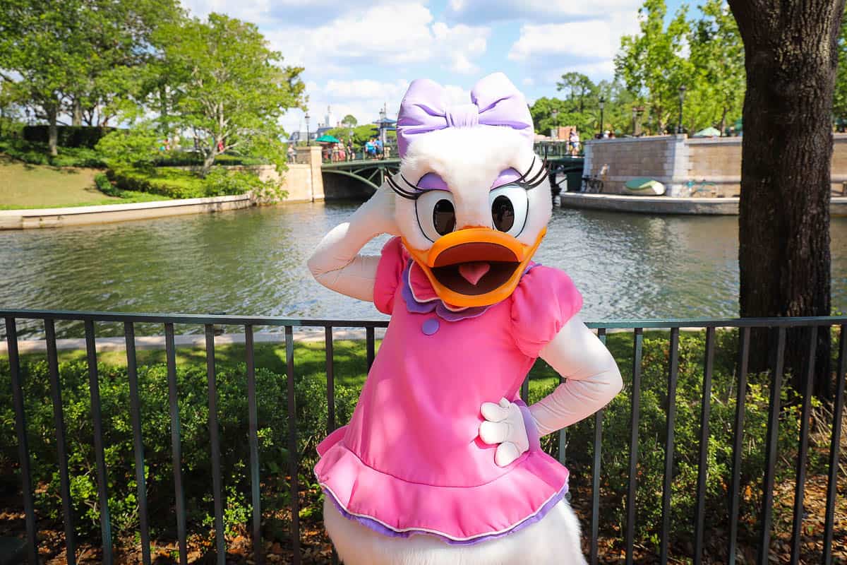Daisy poses for a photo at Epcot's International Gateway 
