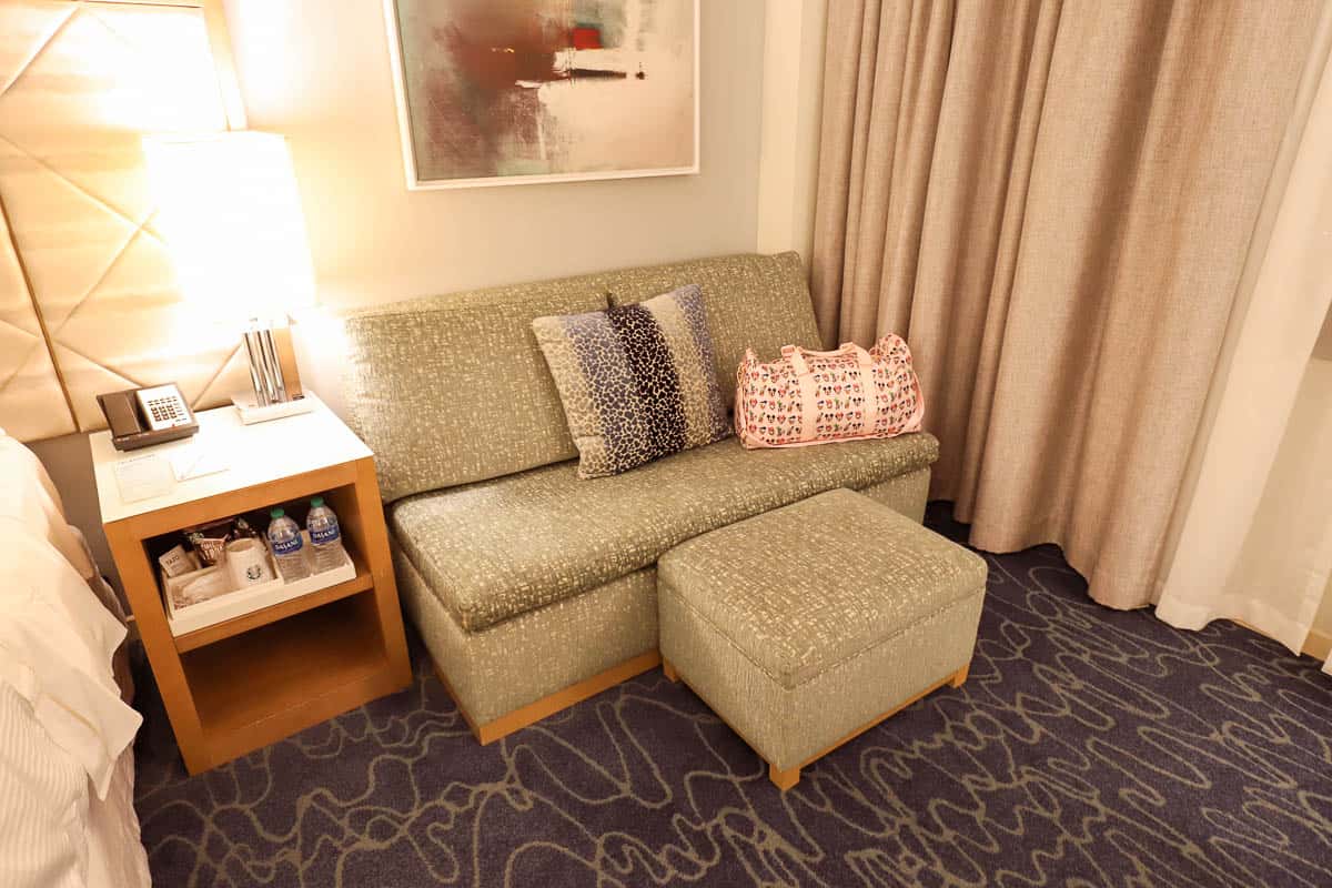 a mini sofa with an ottoman in a room at the Swan 
