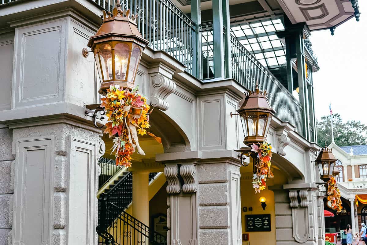 Halloween and Fall colors wrapped around the light sconces at Magic Kingdom 