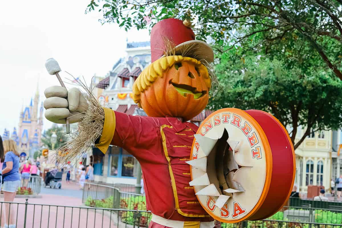 the drummer scarecrow has a pumpkin jack o lantern face 