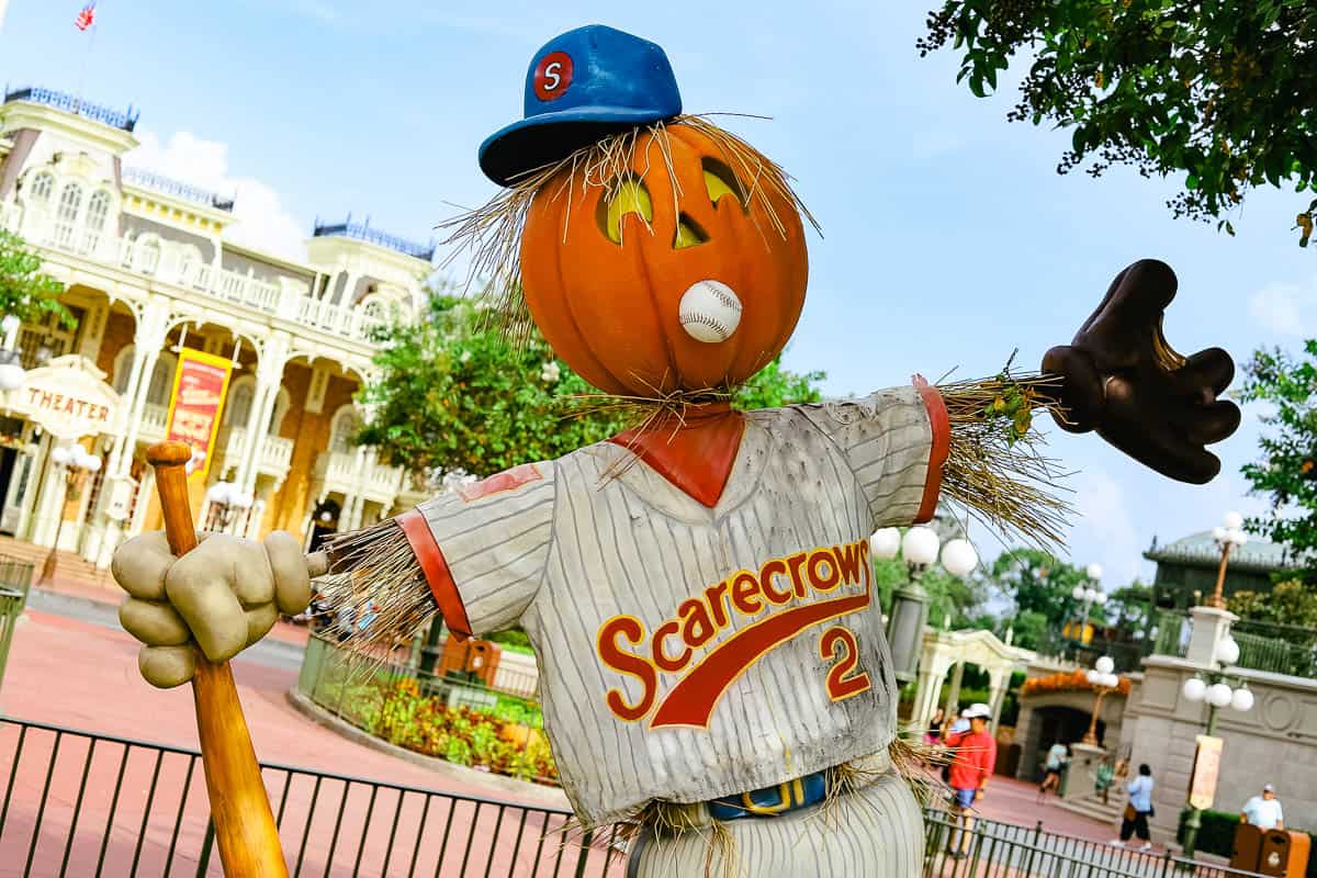 the scarecrow has a baseball stuck in his mouth