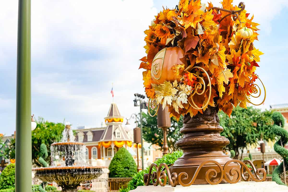 a light pole wrapped in Cinderella Coach pumpkins 