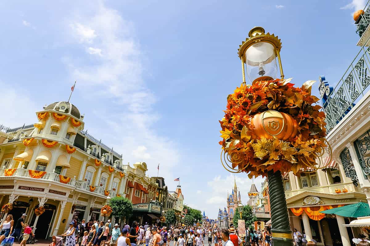 a look down Main Street with a pumpkin wreath on the right during Halloween at Disney World 