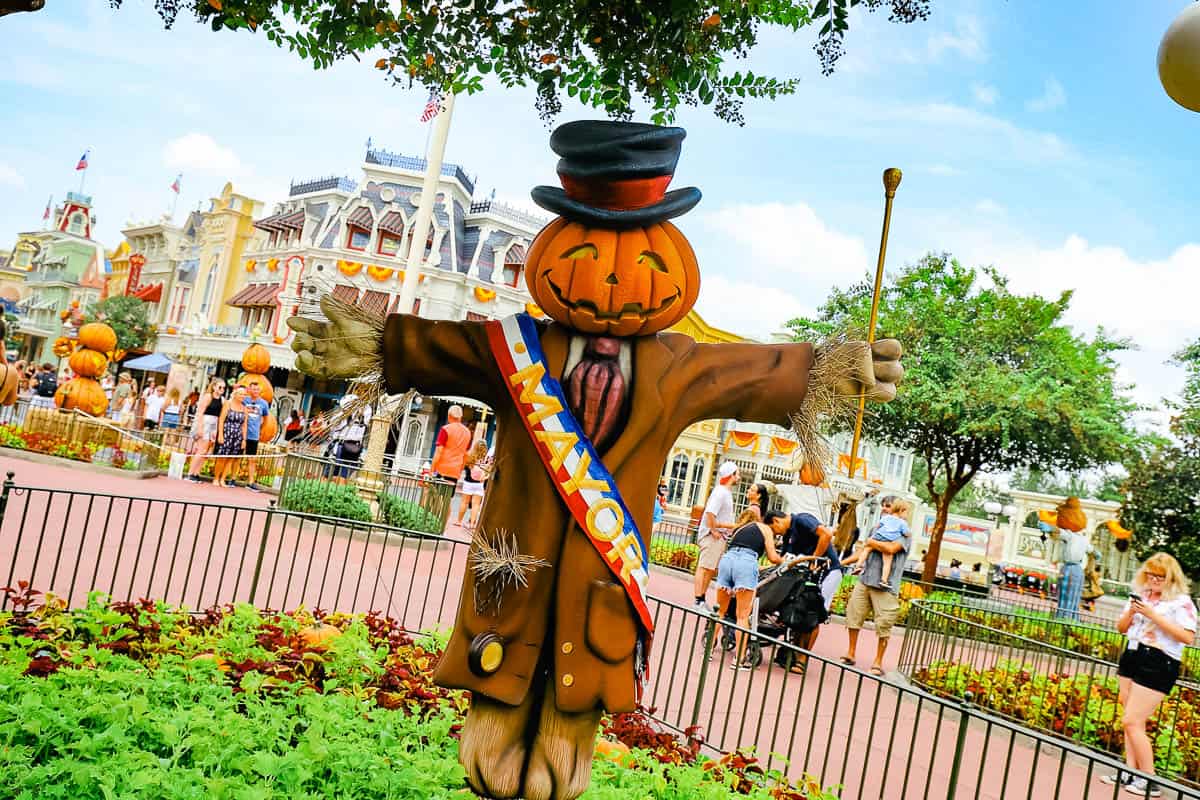 a scarecrow in Town Square wearing a ribbon that says mayor 