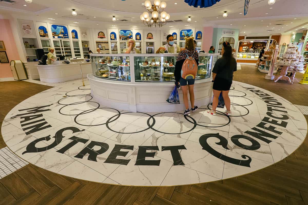 Main Street Confectionery logo on the floor of the Confectionery in white marble with black tile. 