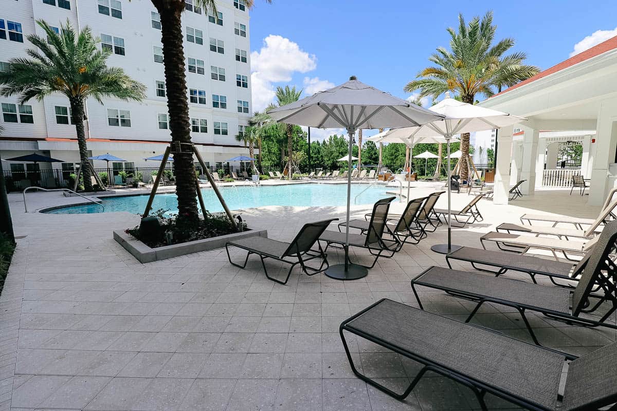 lounge chairs and shaded area surrounding the pool at the Residence Inn at Flamingo Crossings 