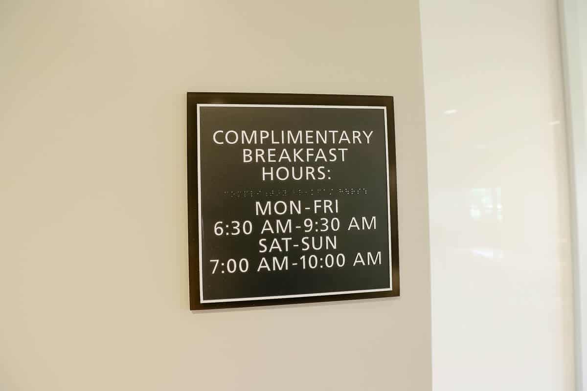 a sign advertising complimentary breakfast hours for the Residence Inn 