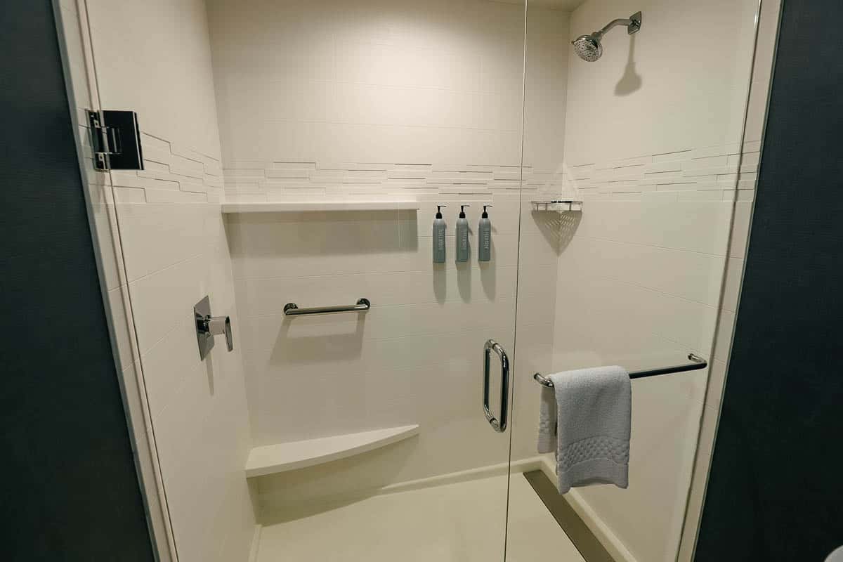 the walk in shower with built in amenities in a studio room at Residence Inn by Marriott Flamingo Crossings 