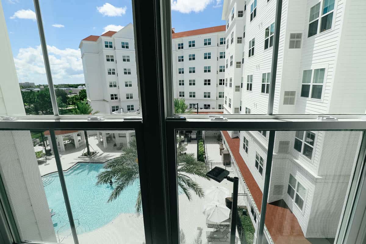 a room with a view of the pool at the Residence Inn Flamingo Crossings 