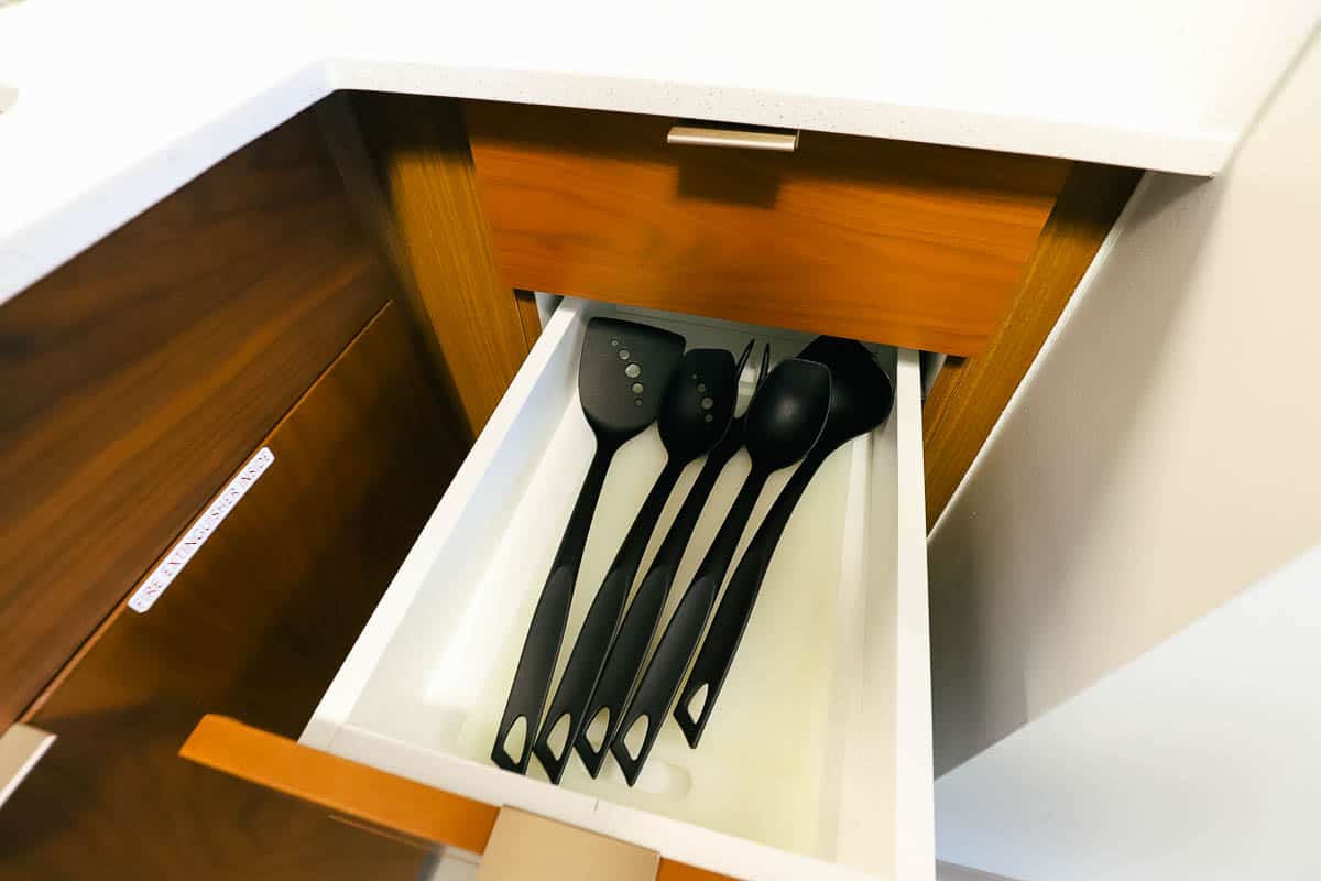 a drawer pulled out to reveal cooking utensils 