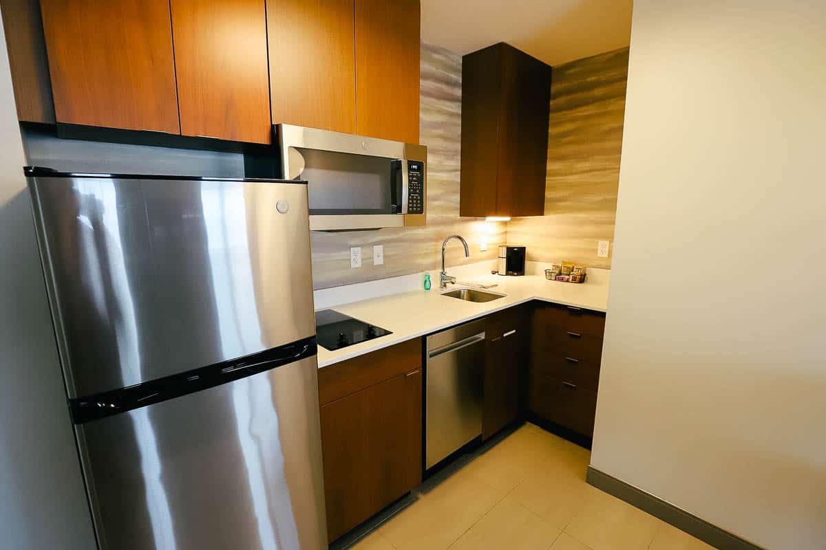 the kitchen had counter space, a small sink, a microwave, a full size fridge 