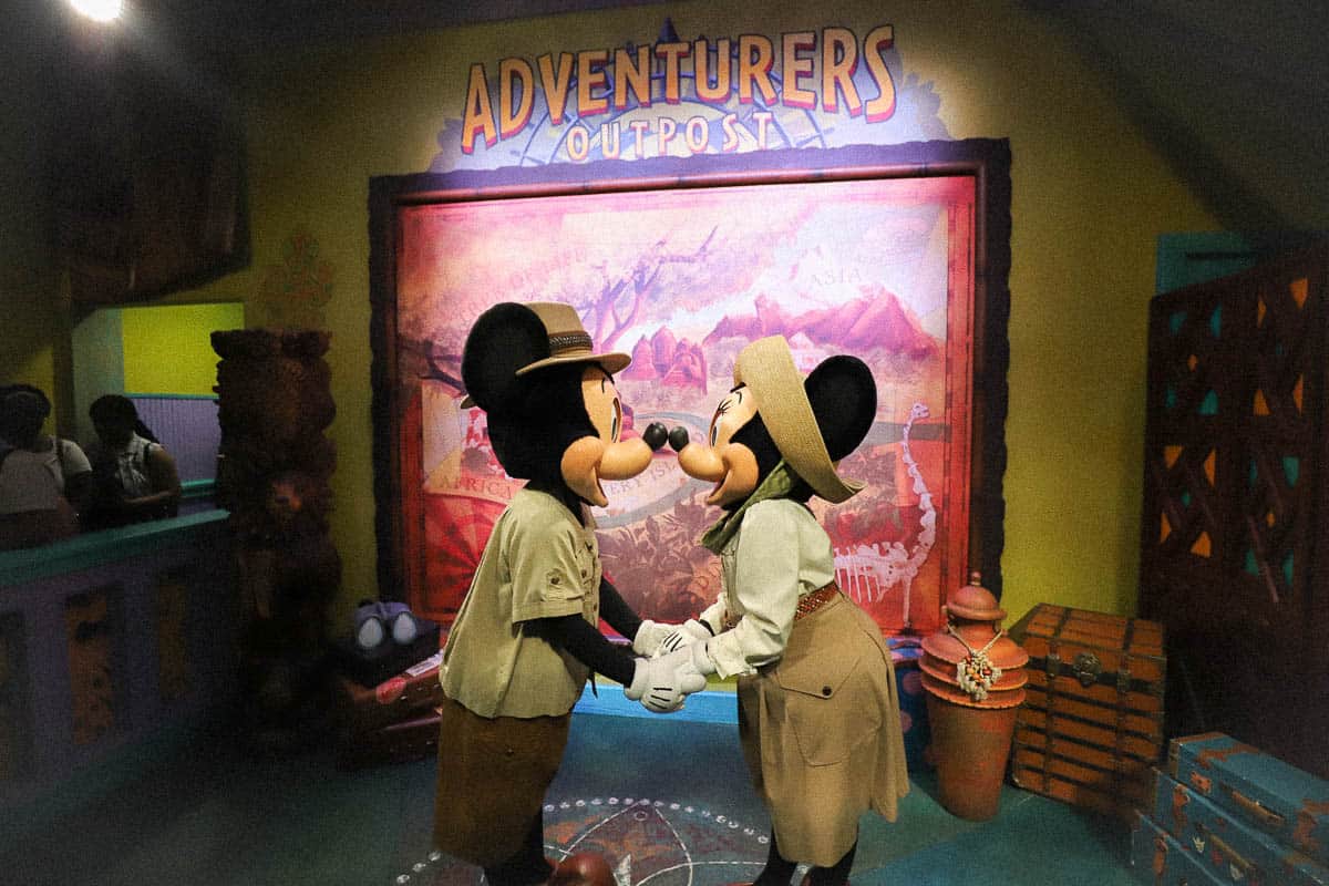 Mickey and Minnie Mouse pose nose to nose for a photo at Adventurer's Outpost. 