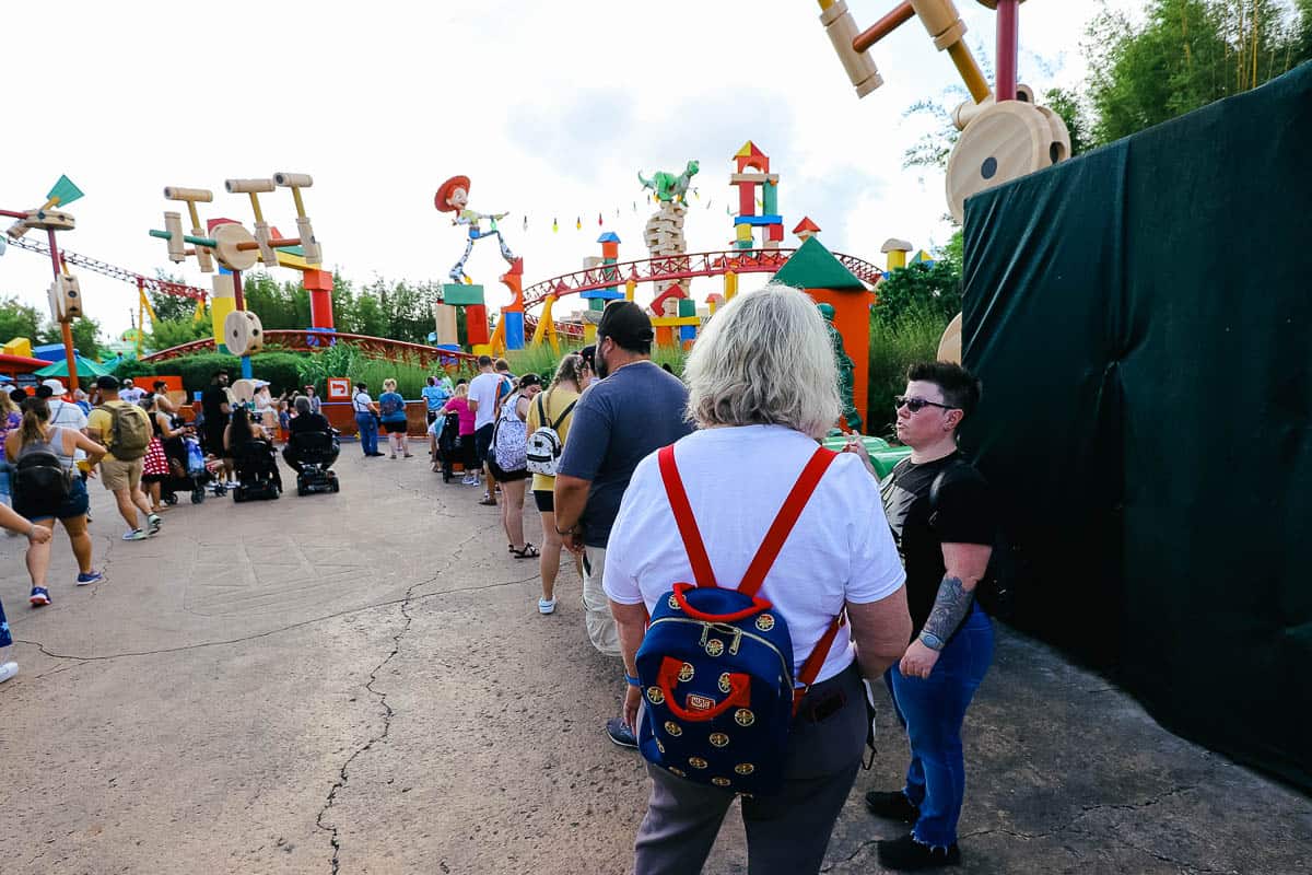 a group of guests waiting to meet Buzz Lightyear 