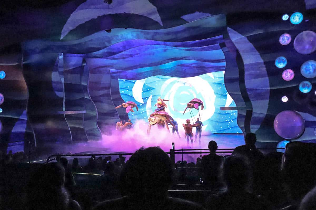 Crush on stage with other turtles performing 'Go with the Flow' at Finding Nemo: The Big Blue and Beyond 