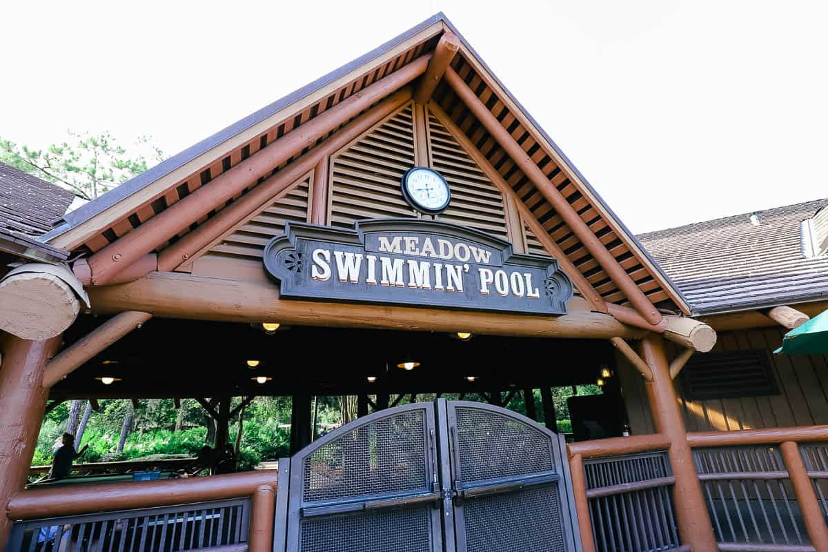 a sign and gate to the Meadow Swimmin' Pool 