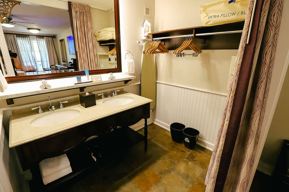 the guest bath with a double vanity and open closet area 