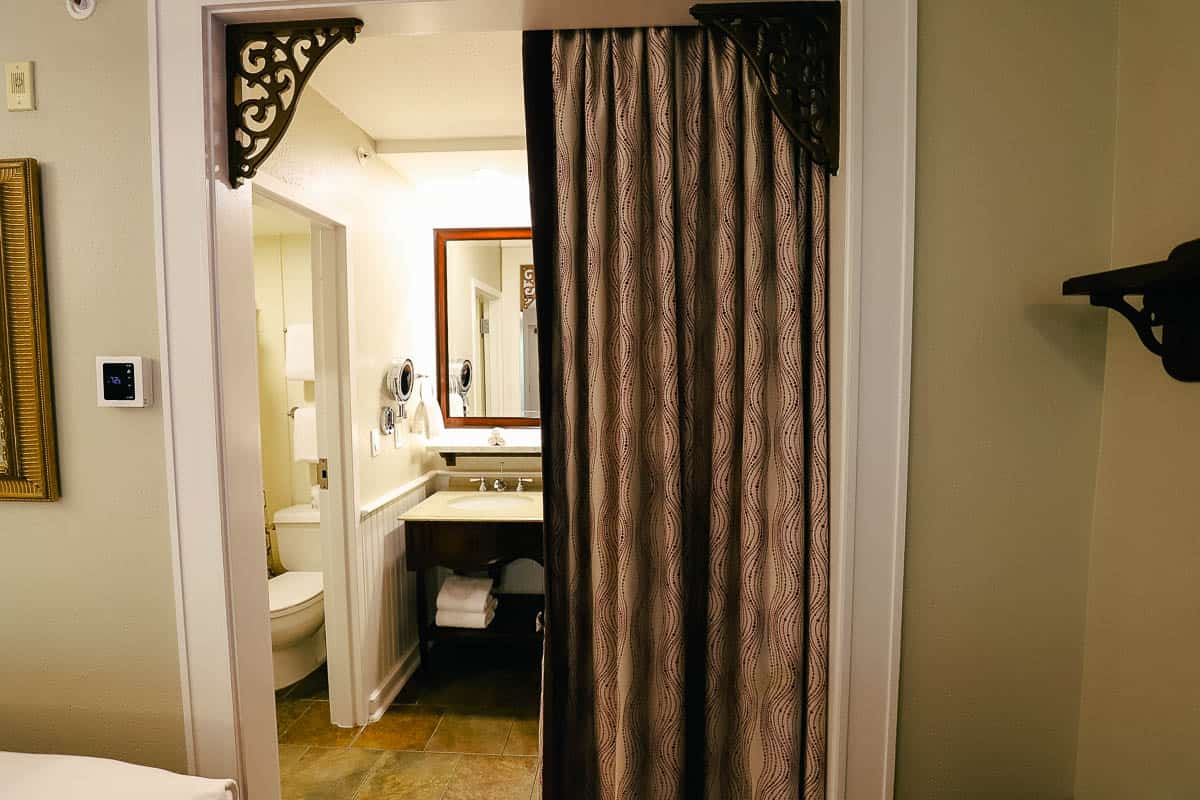 a divider curtain between the room and the bath area 