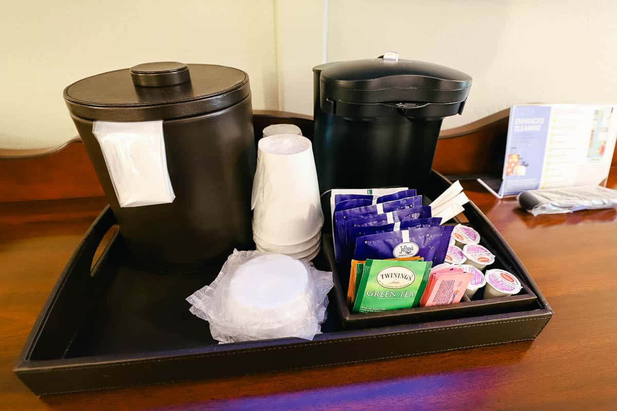 an individual coffee maker with ice bucket and other accompaniments 