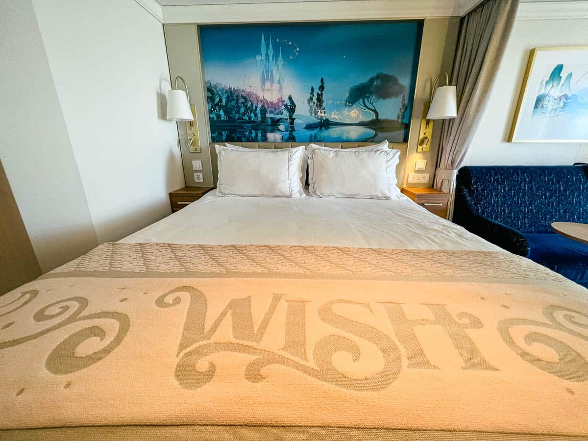 queen size bed in the Ocean View Stateroom on the Disney Wish 