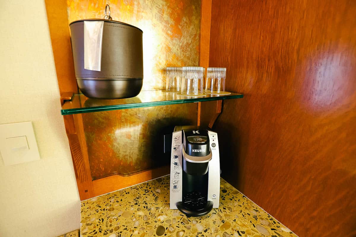 Keurig Coffee maker on a stand with glassware and an ice bucket 