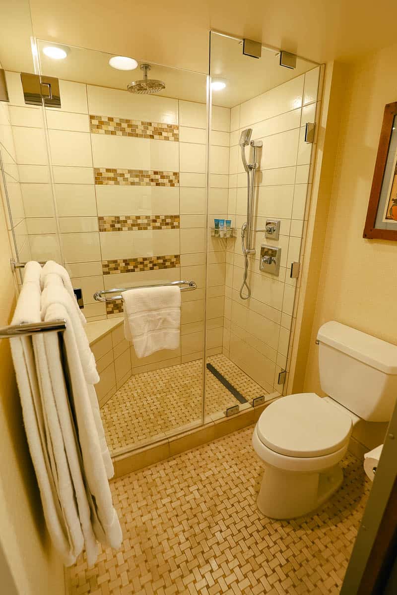 alternate view of the walk-in tile shower with rain-head fixture, and bench 