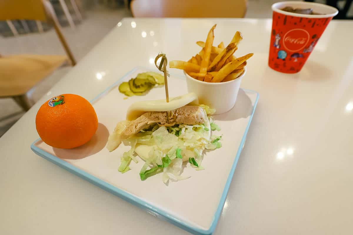 Kids meal chicken bao bun with a Mandarin orange 