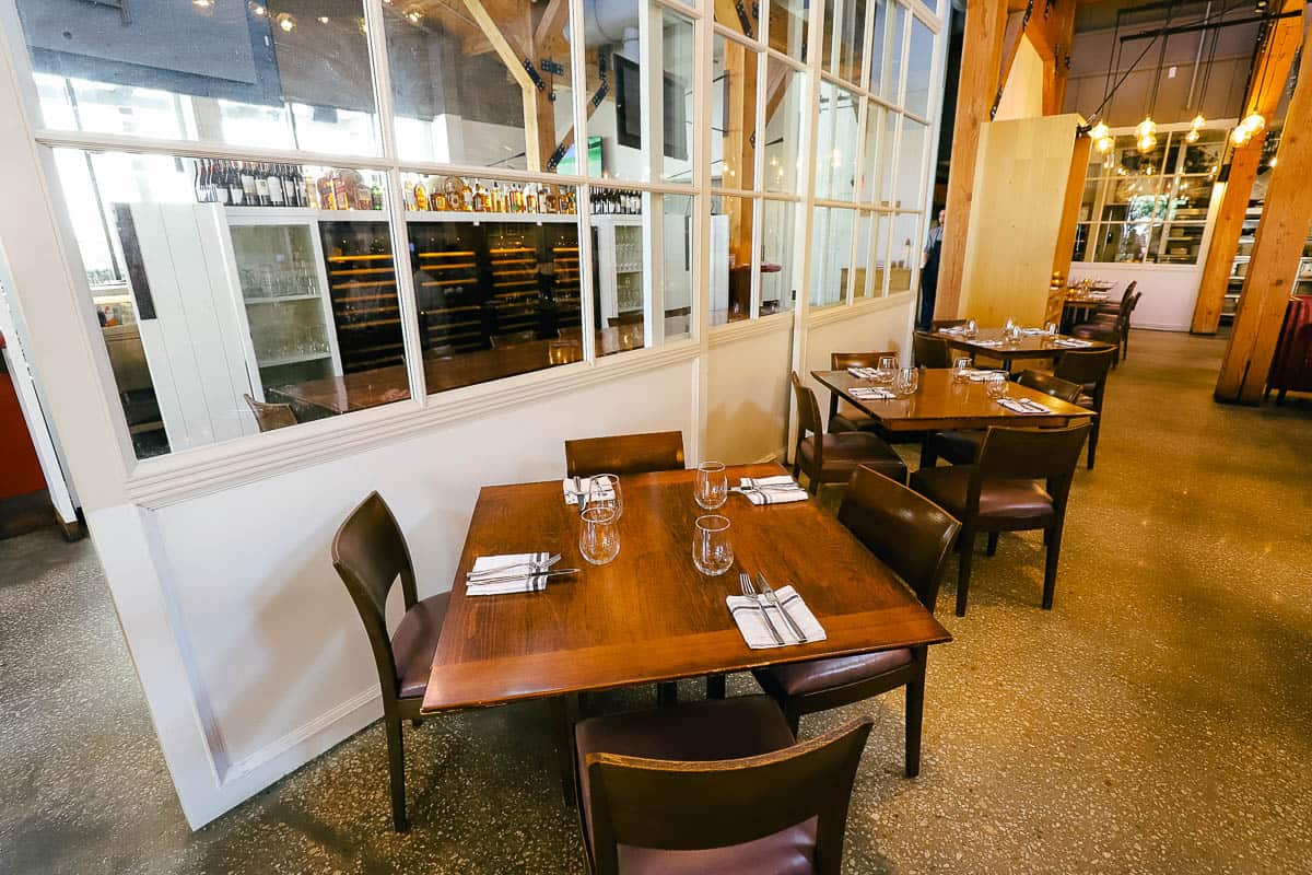 a row of tables and chairs inside the restaurant 