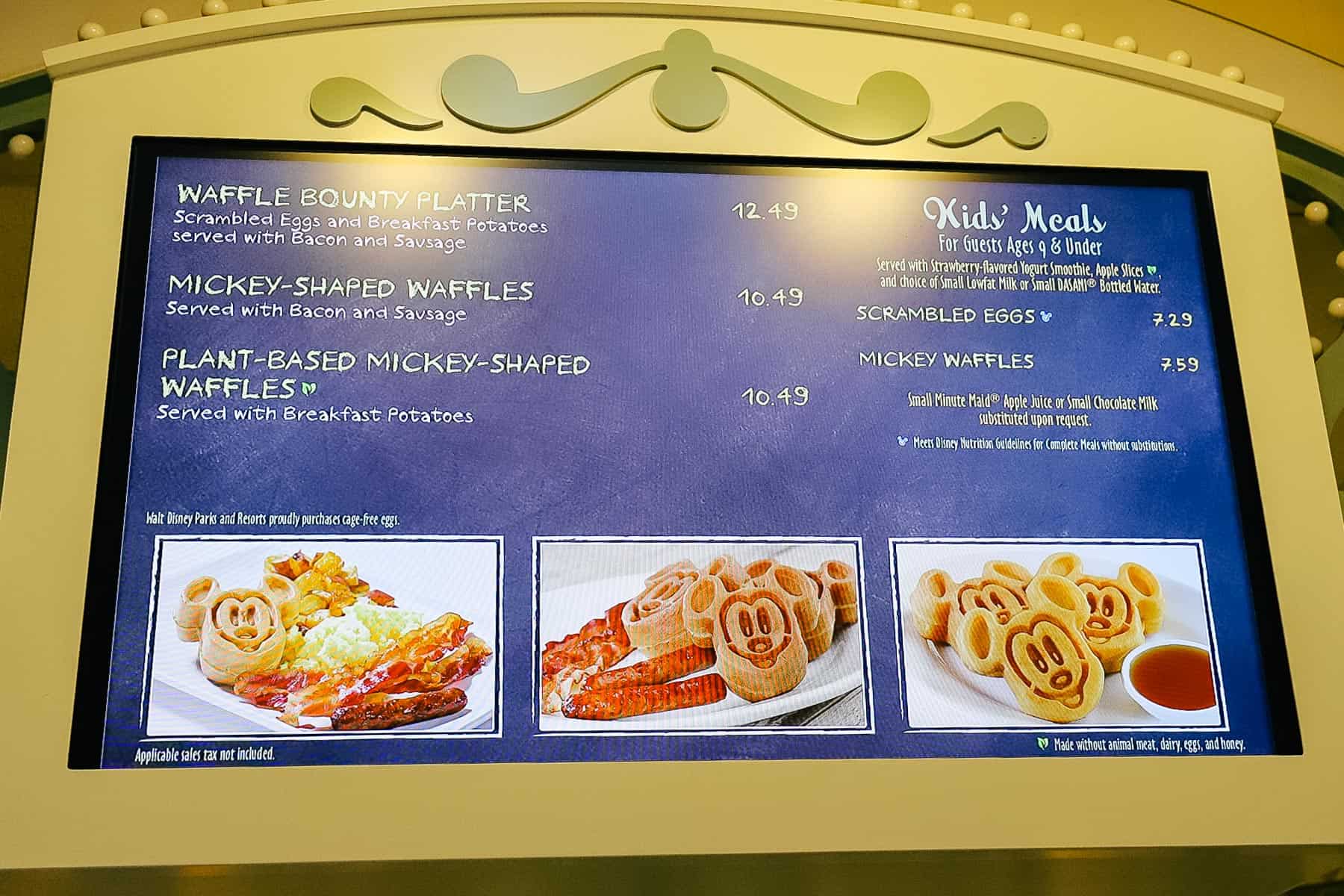 a menu board with Waffle Bounty Platter, Mickey-shaped waffles, and plant-based Mickey waffles 