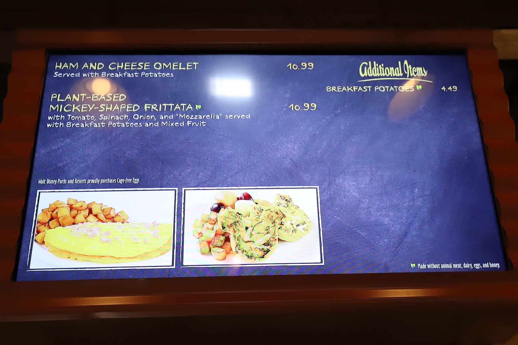 a menu board with ham and cheese omelet and plant-based Mickey-shaped frittata 