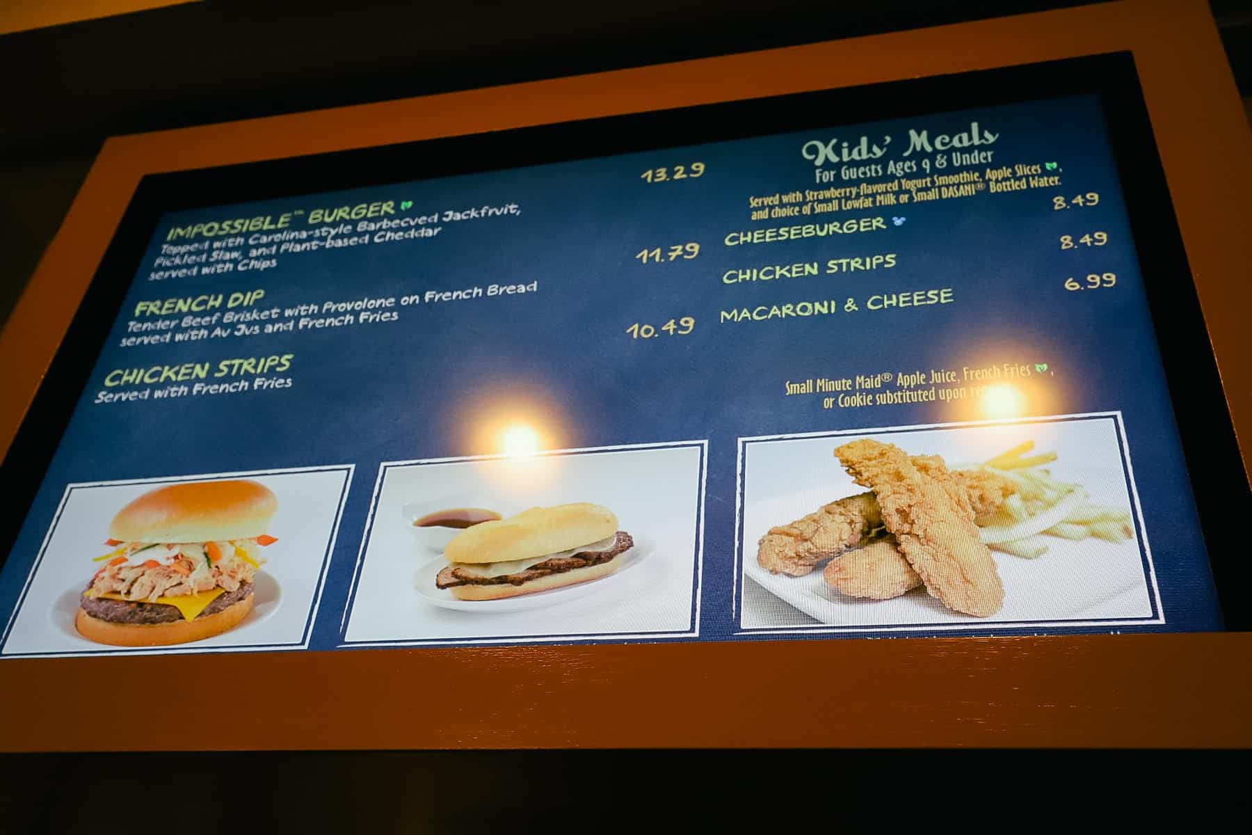 a menu board with a French Dip, Chicken Strips and other Kid's Meals