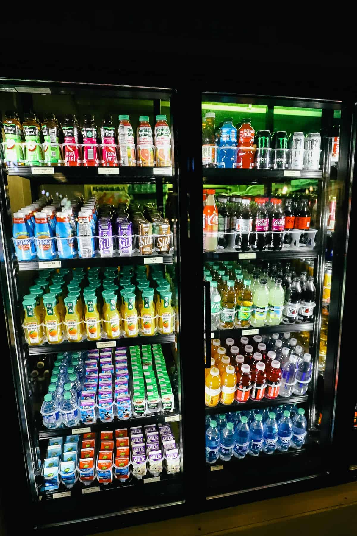 a refrigerated case with beverages like Sports Drinks, juice, milk, soda, and water 