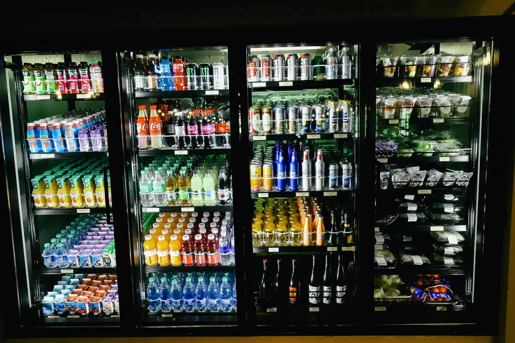 A refrigerated case at Riverside Mill with various milks, beverages, snacks and pre packaged items.