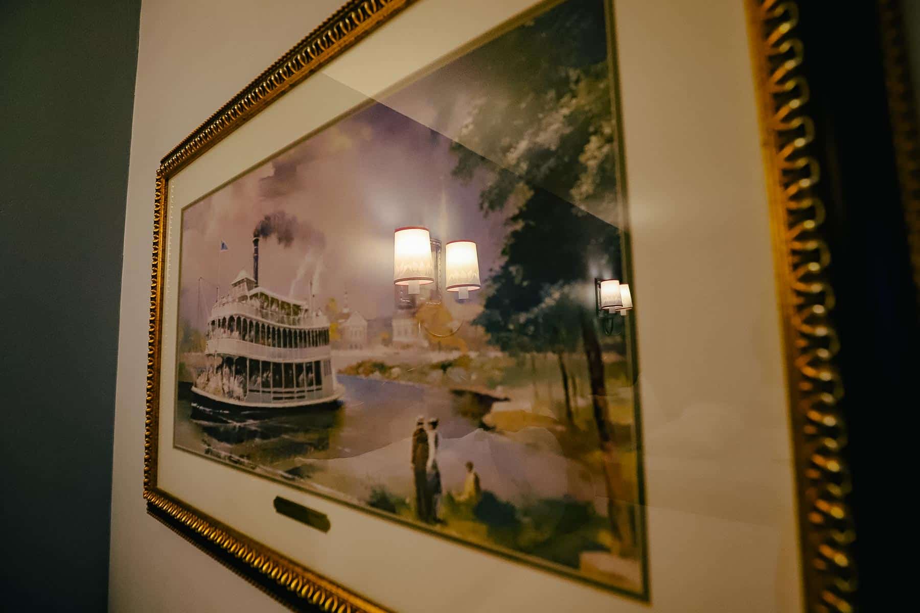 a piece of artwork with a Liberty Belle Riverboat in the Alligator Bayou Room at Port Orleans Riverside 