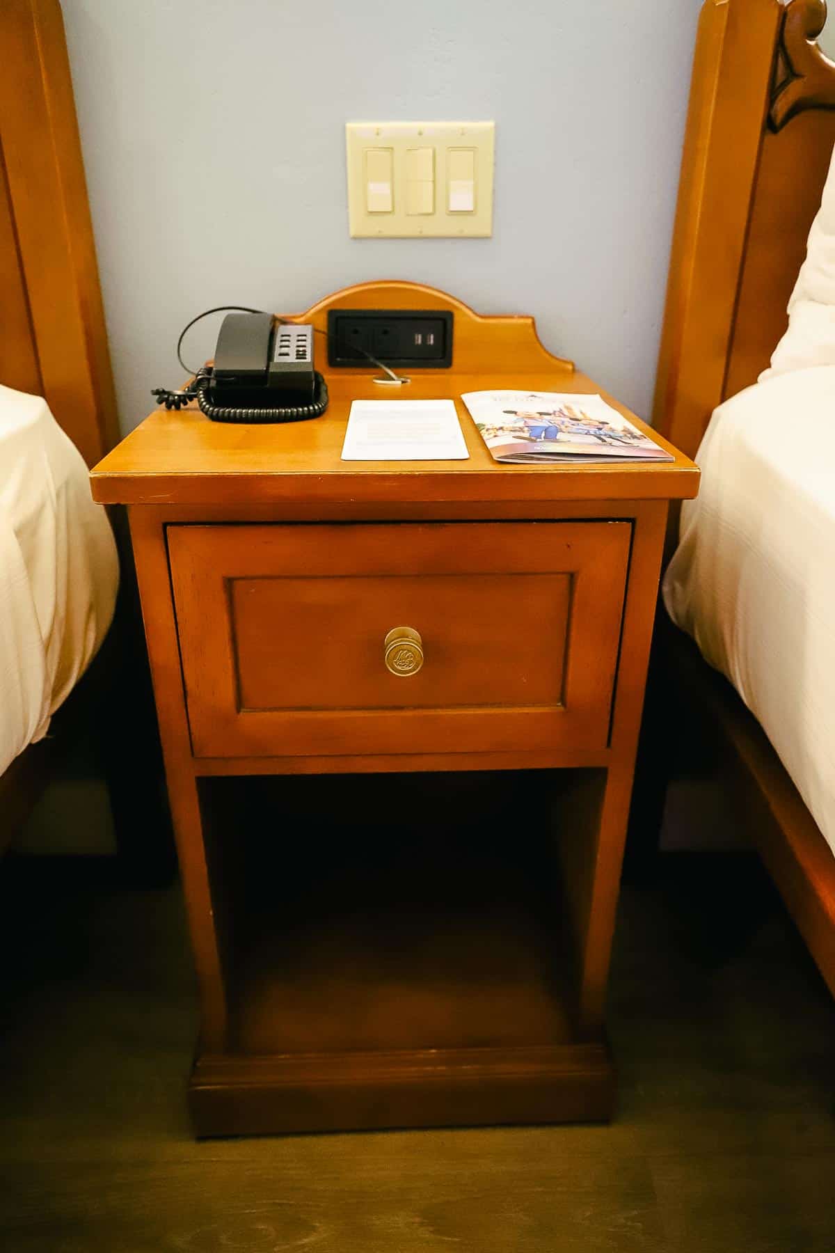 a nightstand between the two beds at Port Orleans Riverside Magnolia Bend 
