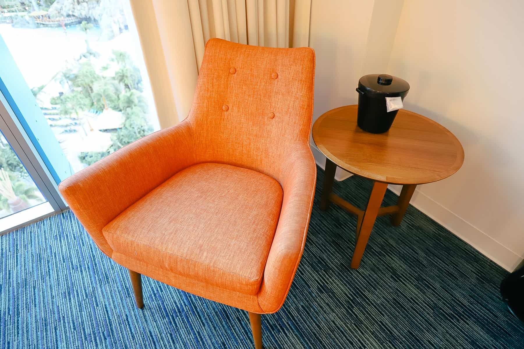 closeup of the orange chair with small table 