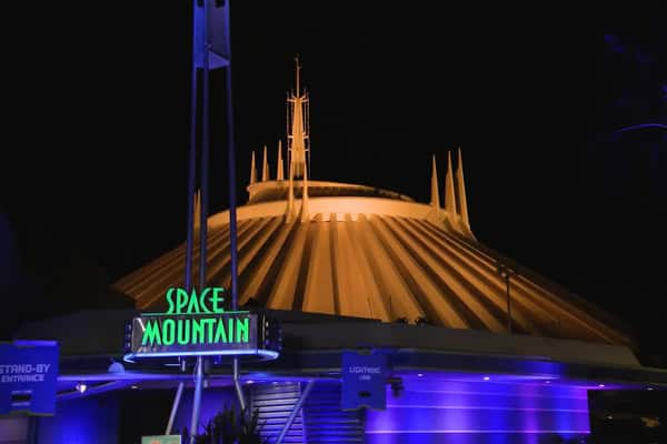 Space Mountain at night with golden look for its 50th anniversary