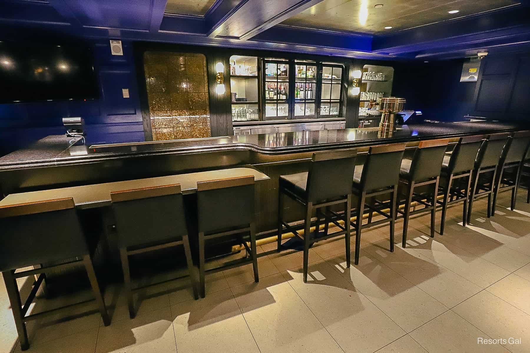 a long bar with stools sits at the back of Ale and Compass Lounge 