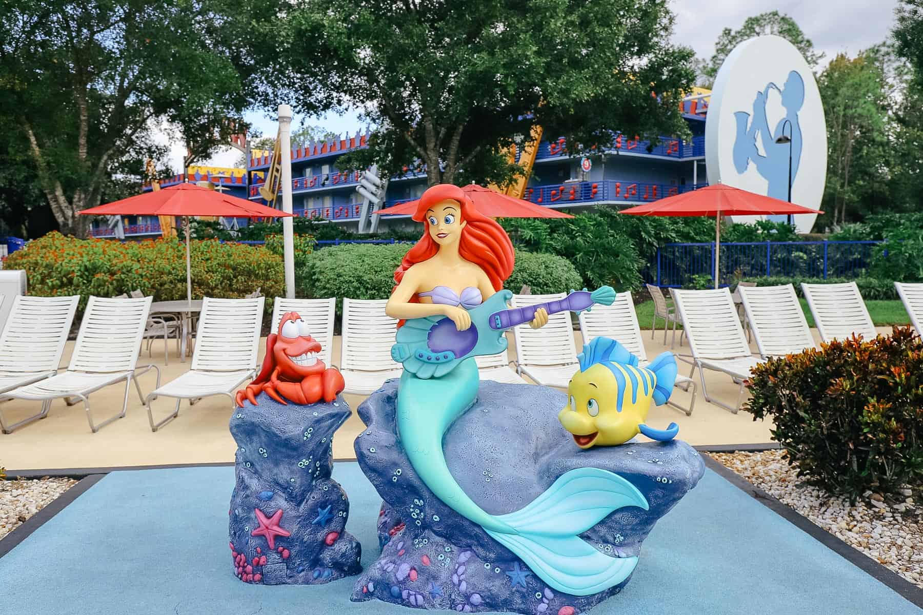 a statue of Ariel, Flounder and Sebastian sitting by the Piano Pool at All-Star Music Resort 