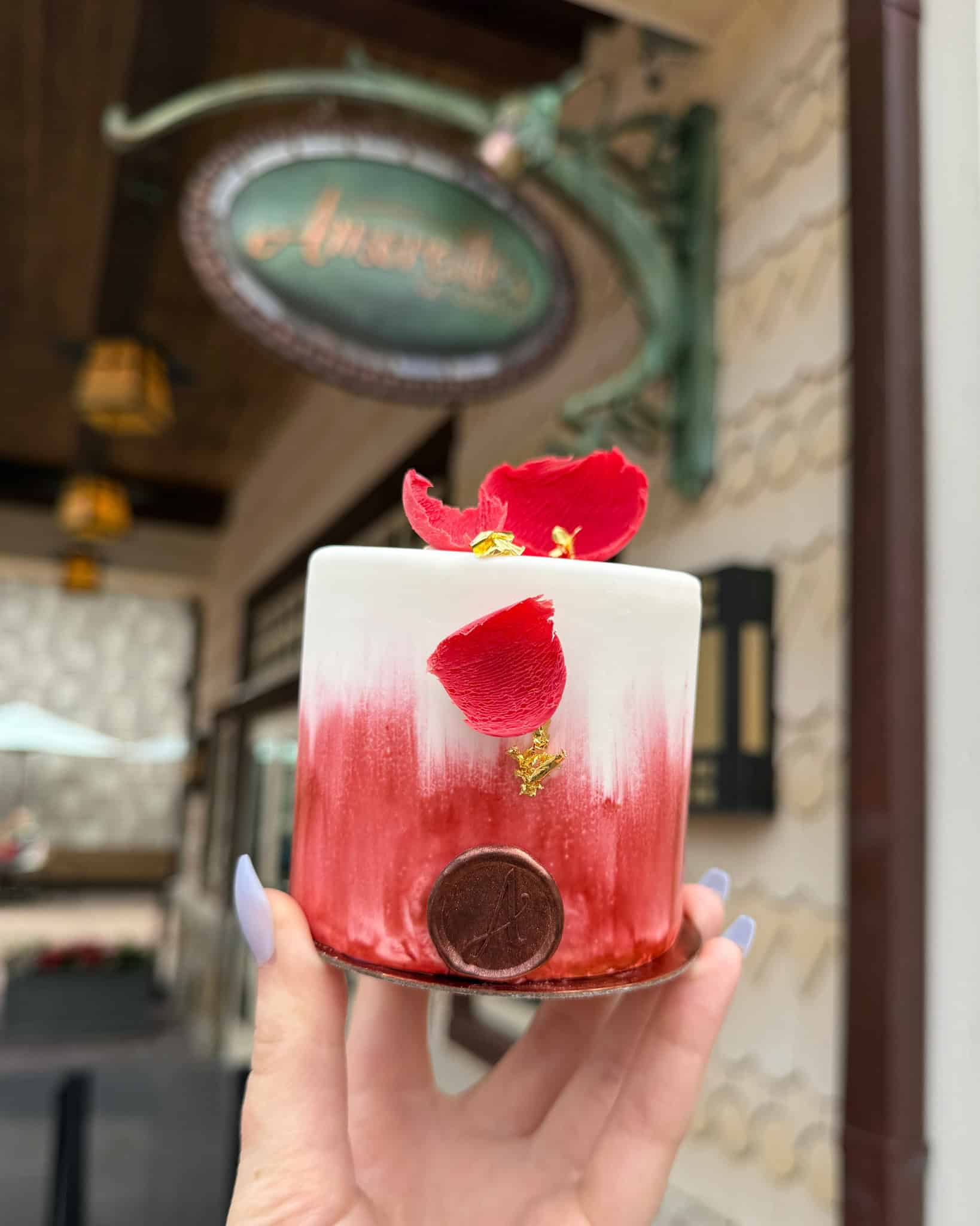 a signature cake with gold foil and edible rose petals 