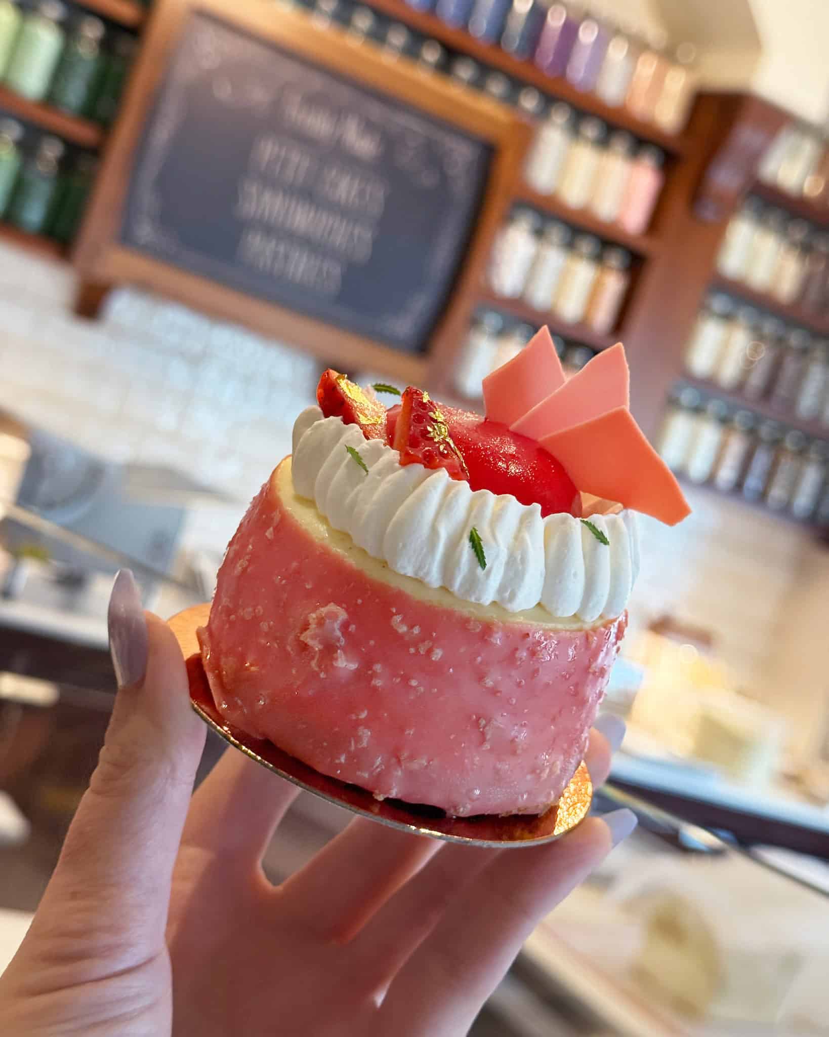 a strawberry cheesecake with whipped topping and garnish 