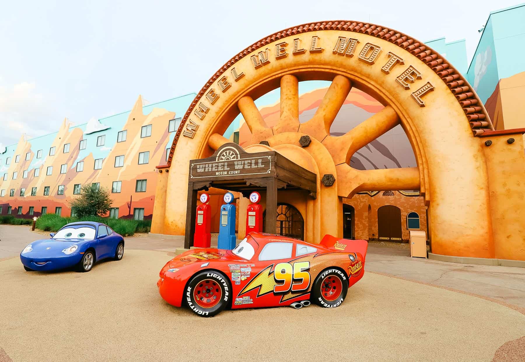 the wheel Well Motel section of Art of Animation with blue car Sally and Lightning McQueen 