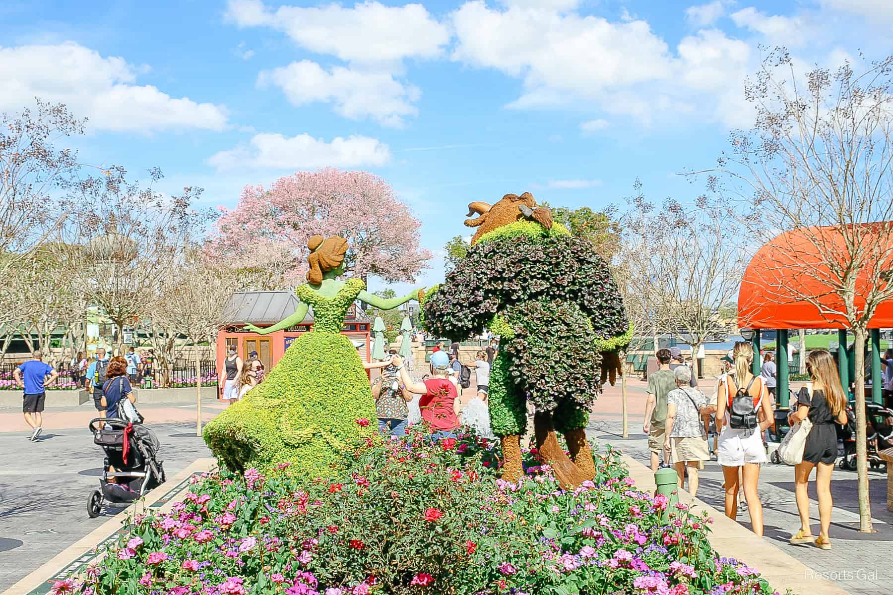 an alternative view that shows the back of the Beauty and the Beast topiary looking toward the World Showcase Lagoon 