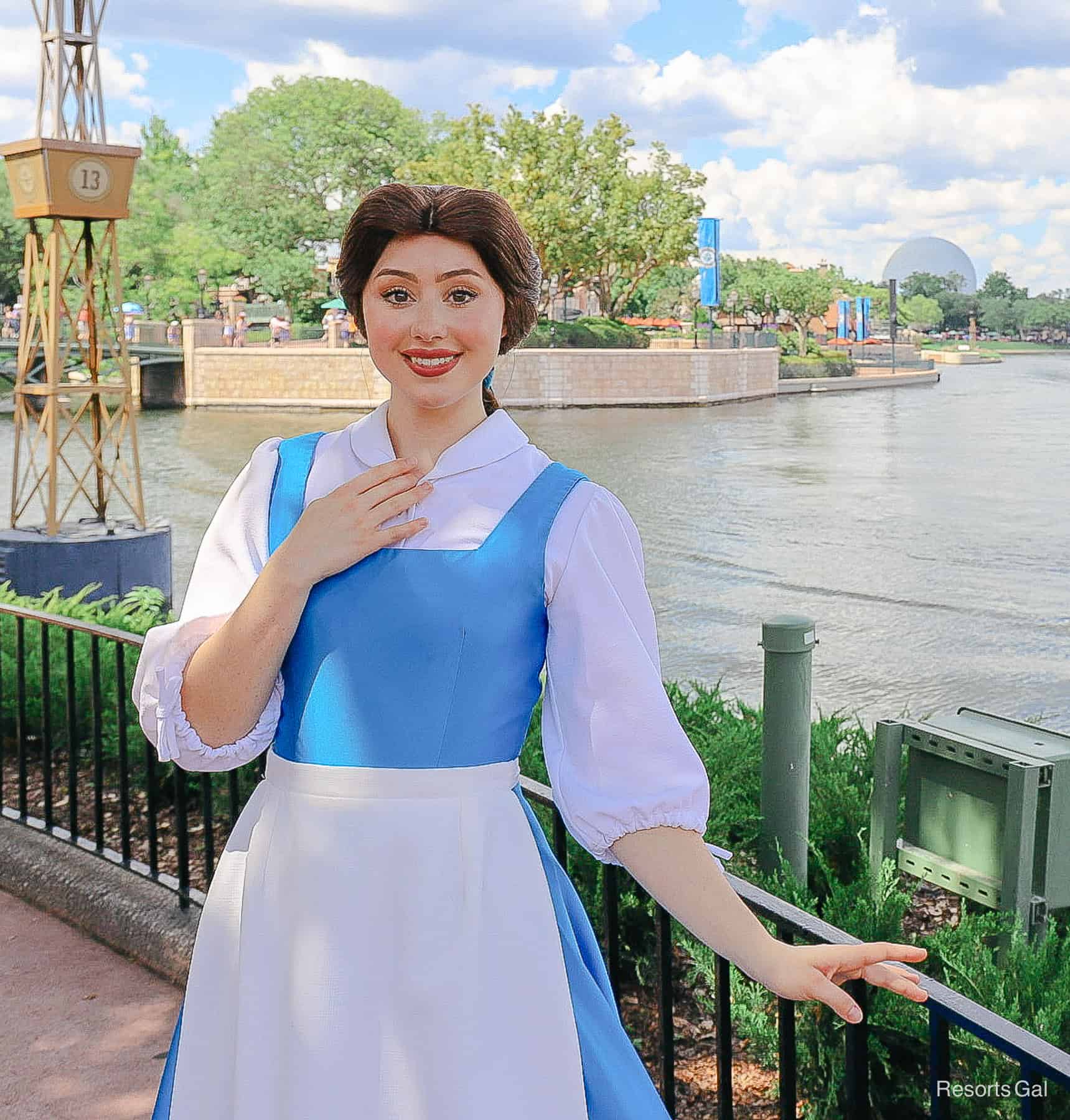 Belle in blue village dress with white apron. 