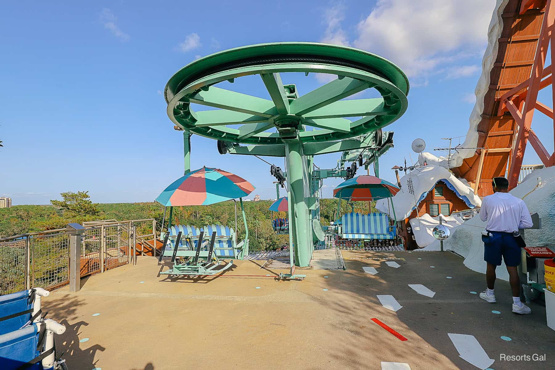 a cast member monitoring the chairlift exit at Disney's Blizzard Beach. 