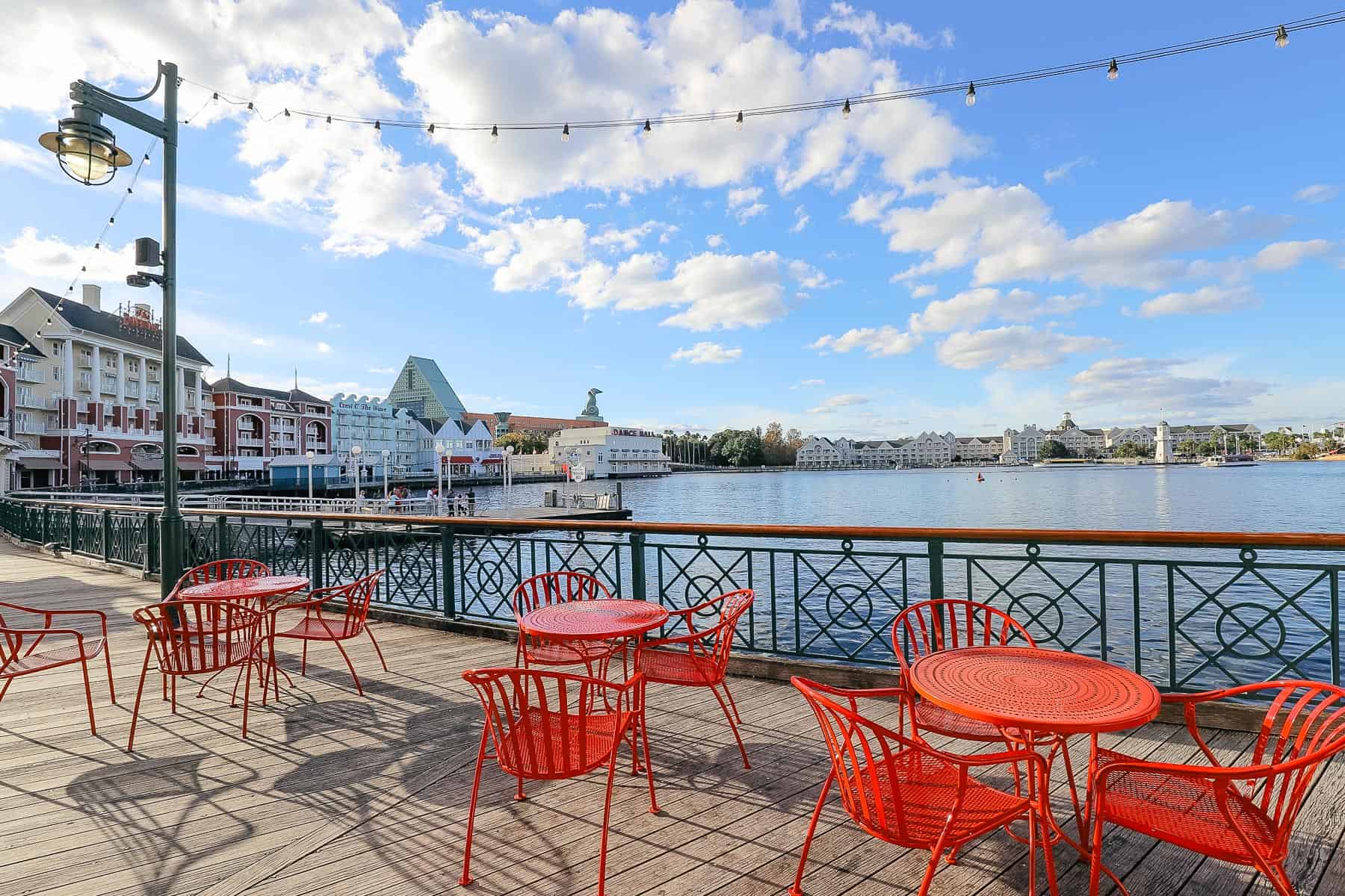 red tables and chairs facing the lake on Disney's Boardwalk 